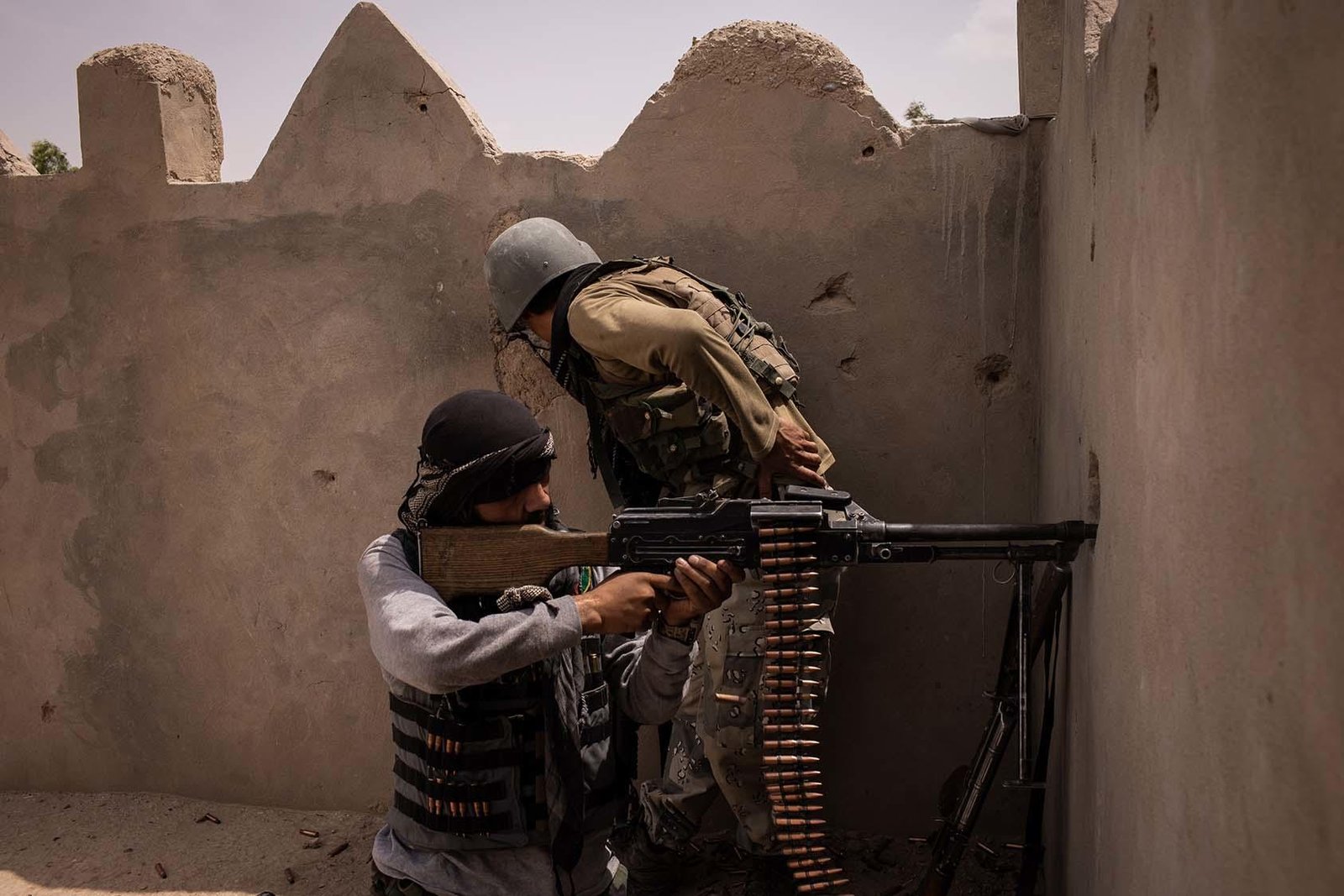 FILE — An Afghan soldier fires a machine gun at Taliban positions in Lashkar Gah, Afghanistan on May 10, 2021. The Taliban have captured the capital of one of Afghanistan’s western provinces, Afghan officials said on Friday, Aug. 6, 2021, a symbolic milestone in the insurgents’ relentless march to retake power in the country. (Jim Huylebroek/The New York Times)