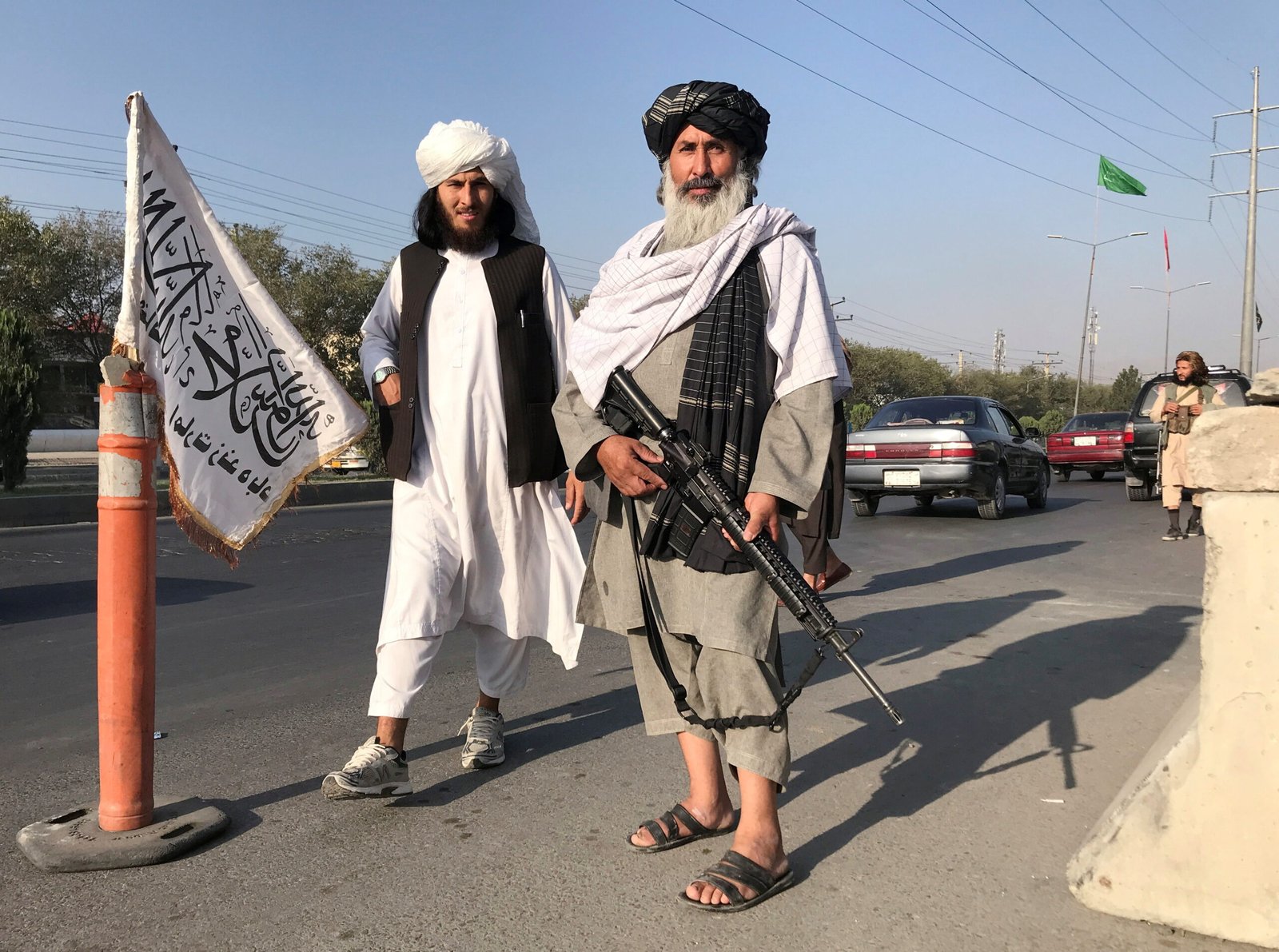 Taliban fighters stand outside the Interior Ministry in Kabul, Afghanistan, August 16, 2021.